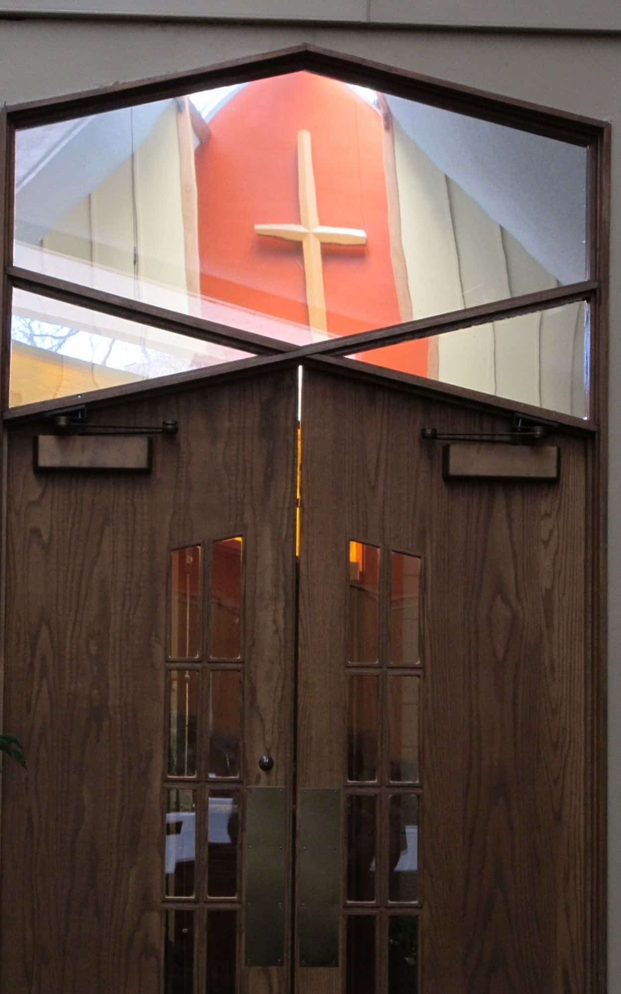 Doors to the foyer from Nave showing reflection of the Altarpiece