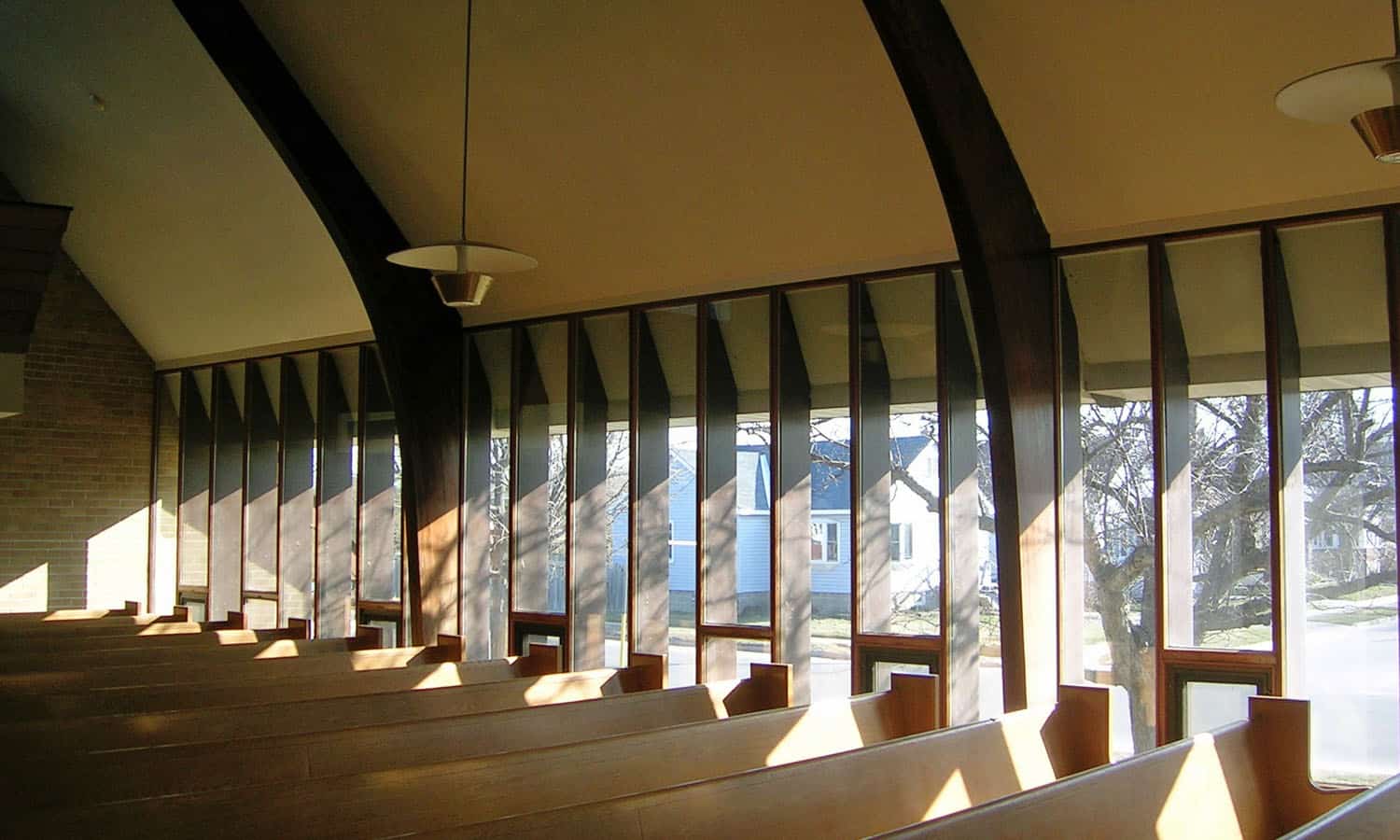 Windows along the edge of the sanctuary allowing filtered light to enter