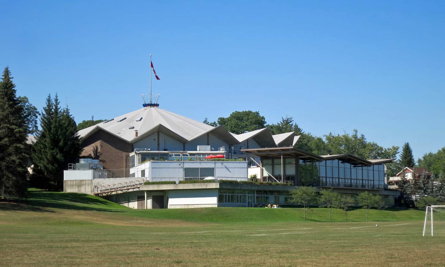 Festival Theatre and its additions overlooking parkland and Avon River