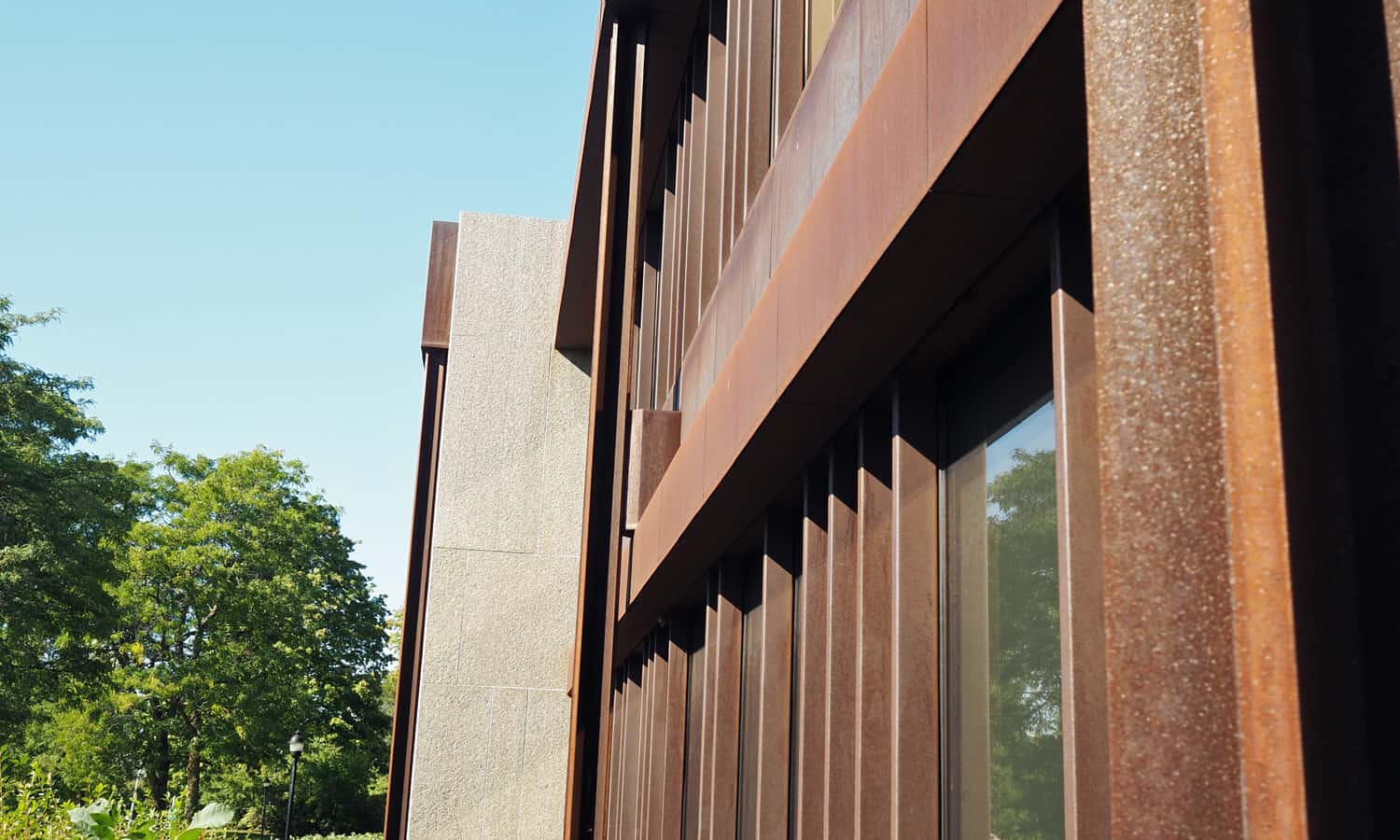 Detail highlighting the depth and shadow play present in the Cor Ten cladding system