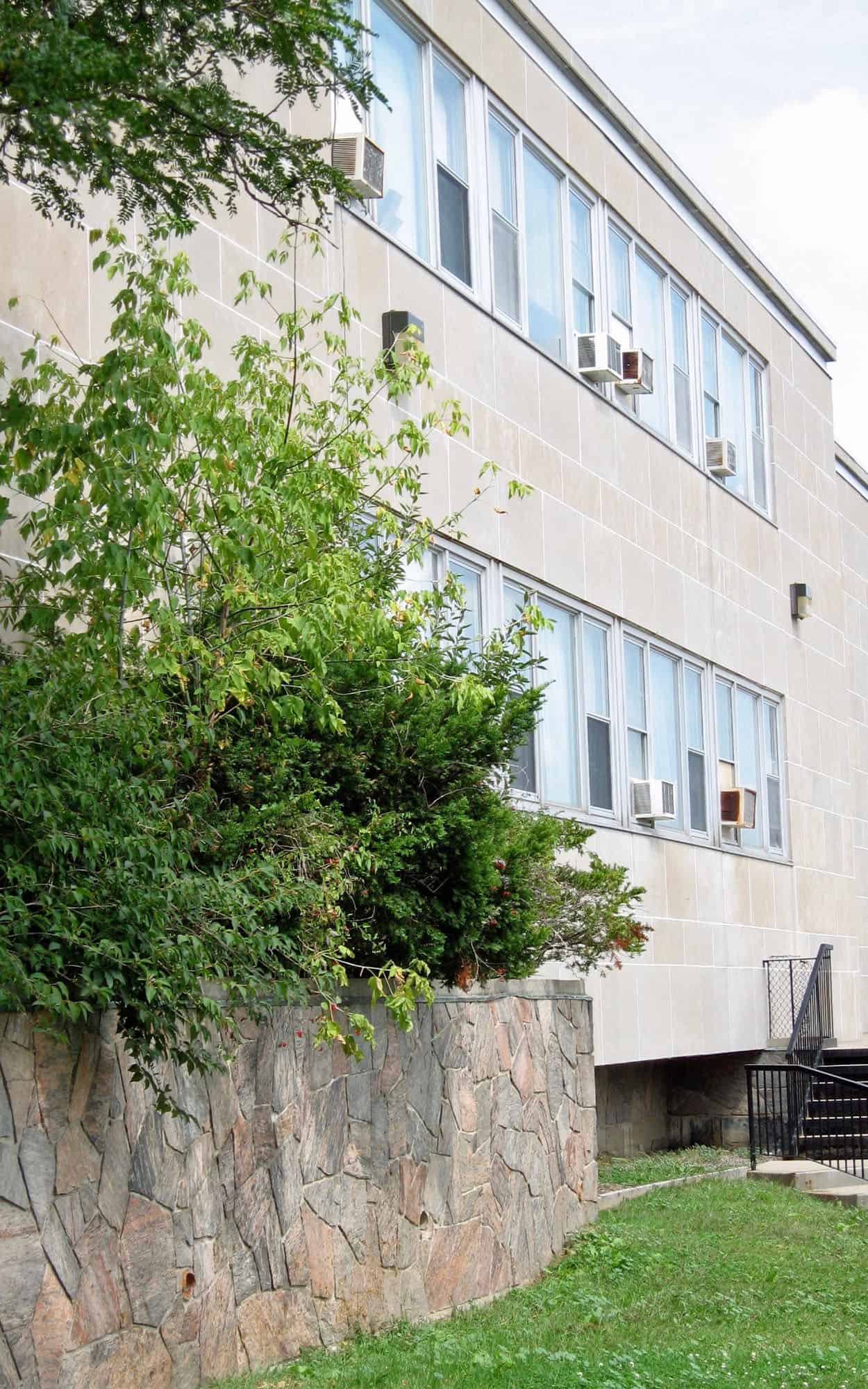 Smooth limestone cladding ribbon windows and granite clad garden wall