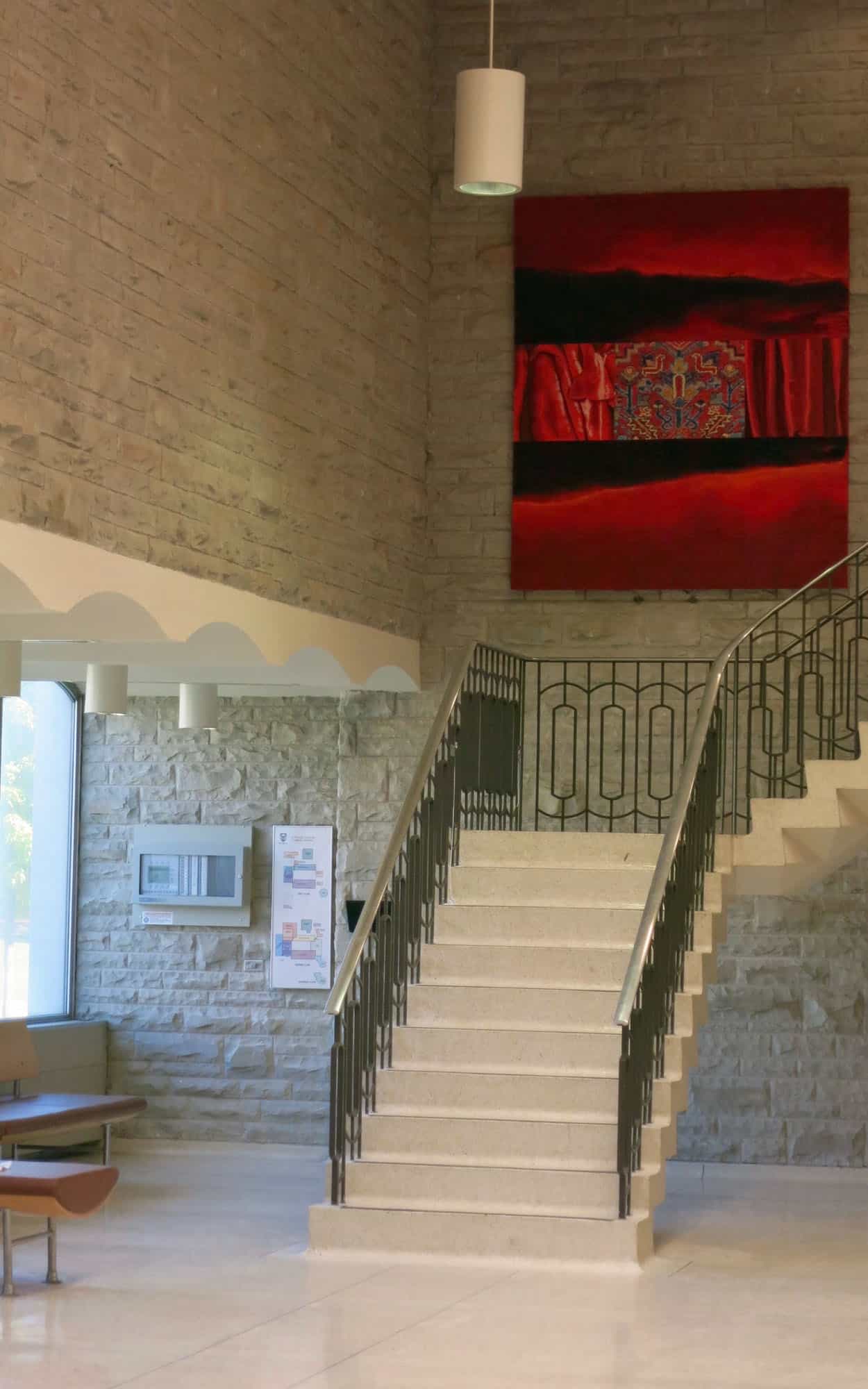 The floating stair finished in terrazzo with its steel and brass balustrade