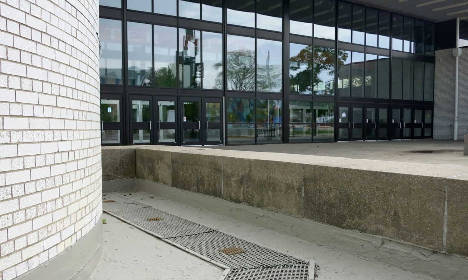 A reflecting pool forms a moat at the north elevation