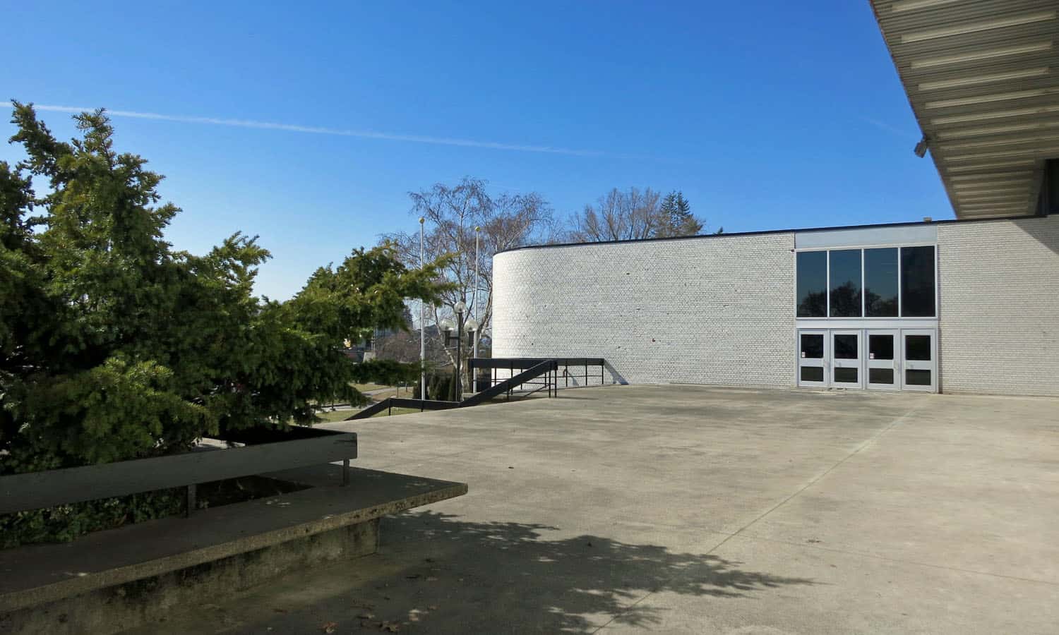 Entrances, such as this one at the south, are characterized by broad concrete terraces and steps