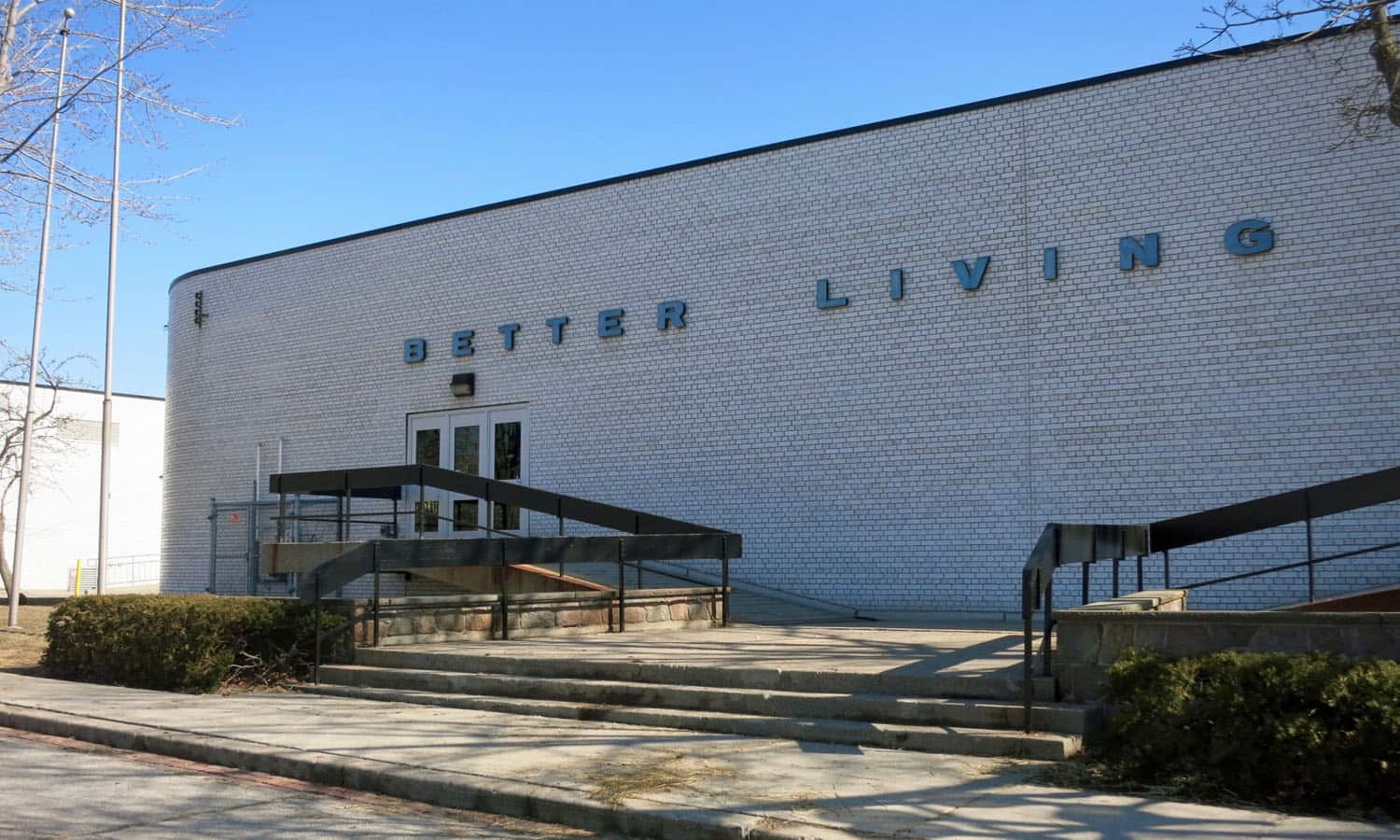 The west elevation with its wide expanses of white glazed brick, integrated signage, and symmetrical exits